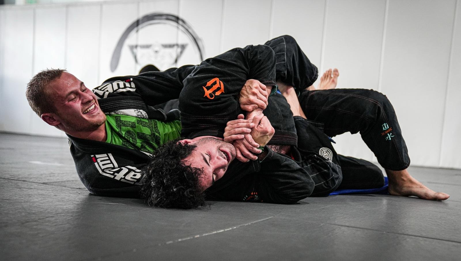 Zev Schachter smiling while applying an armlock during Jiu Jitsu training.